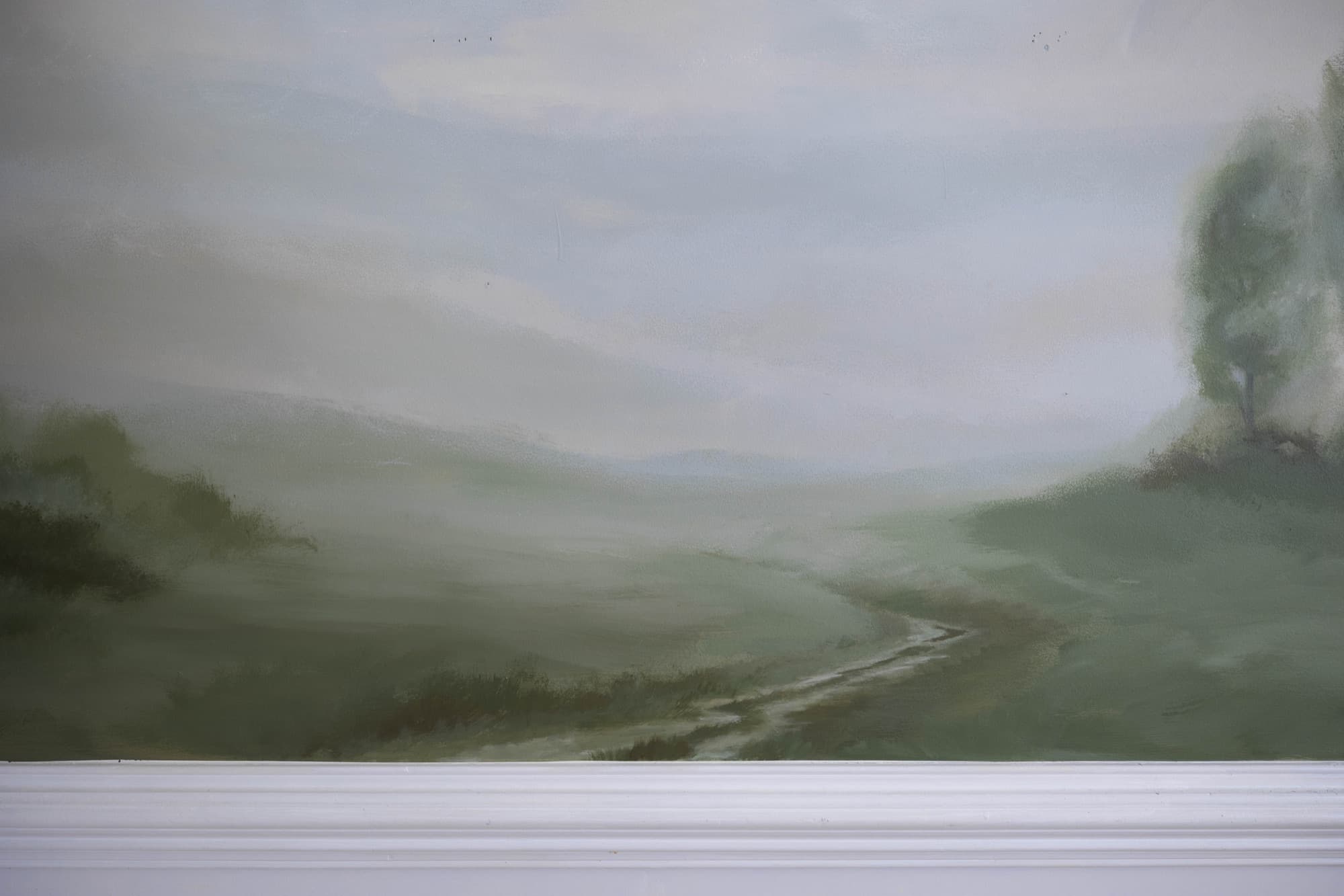 Sage landscape mural across a wide wall.